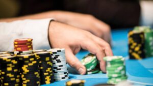 pokerinpelaaja nappaa joukon pelimerkkejä